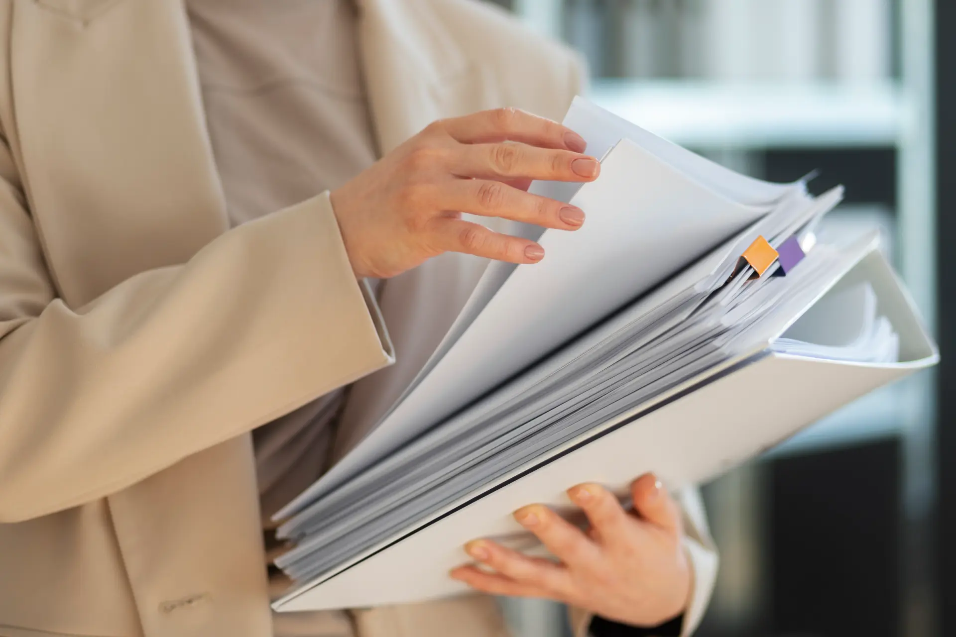 a woman holding a stack of papers